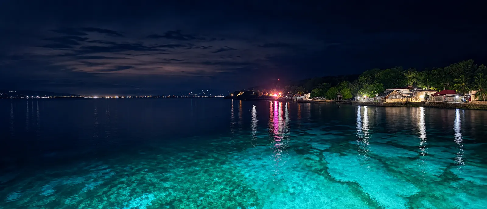 Night view over clear tropical water near the shore
